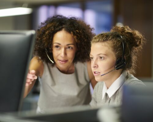 a female call centre worker trains an intern